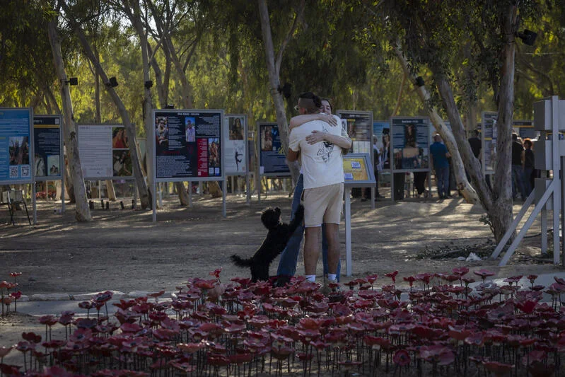 Family members and visitors gather at the Nova music festival memorial site near Kibbutz Re’im