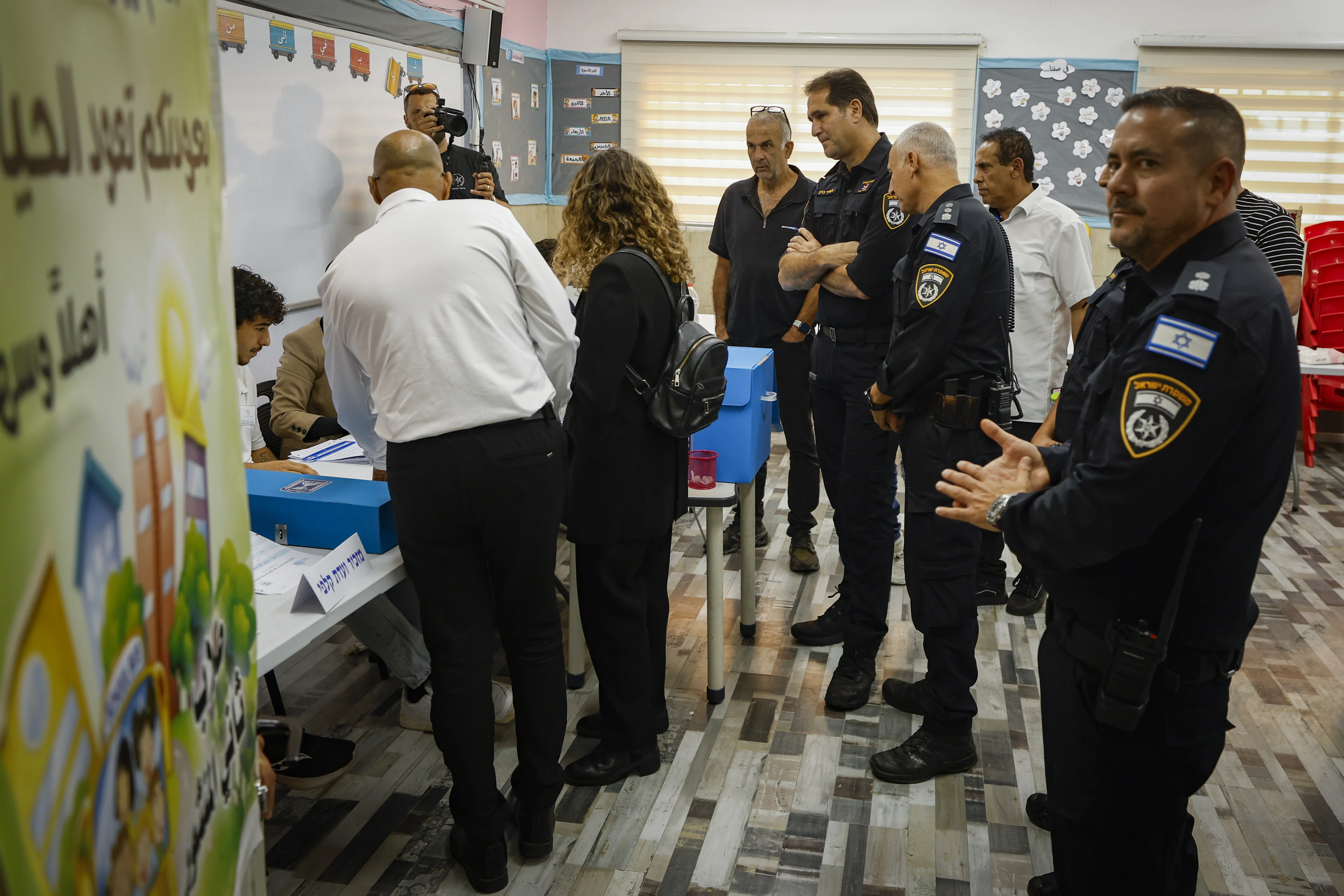 Arab Israelis arrive to cast their ballots at a polling station in the Arab city of Tayibe, central Israel