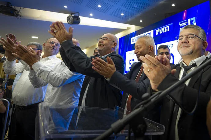 Joint List party chairman Yousef Jabareen and supporters gather at the party’s election headquarters in the northern Israeli city of Nazareth