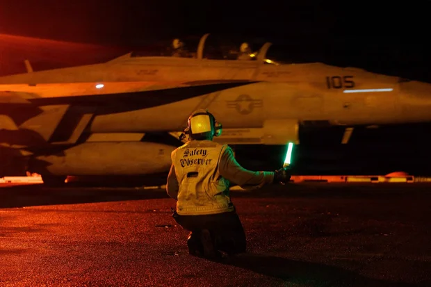 U.S. Sailors signal an F/A-18E Super Hornet on the deck of USS George H.W. Bush (CVN 77) as the aircraft carrier transits the Arabian Sea. . July 22, 2026 Photo: US Centcom