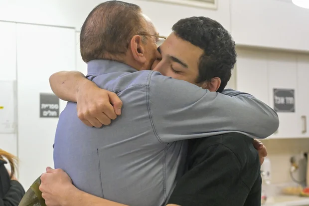 Staff Sgt. Edan Alexander embraces a family member during an emotional reunion at Tel Aviv Sourasky Medical Center, Israel, May 12, 2025. Photo: GPO