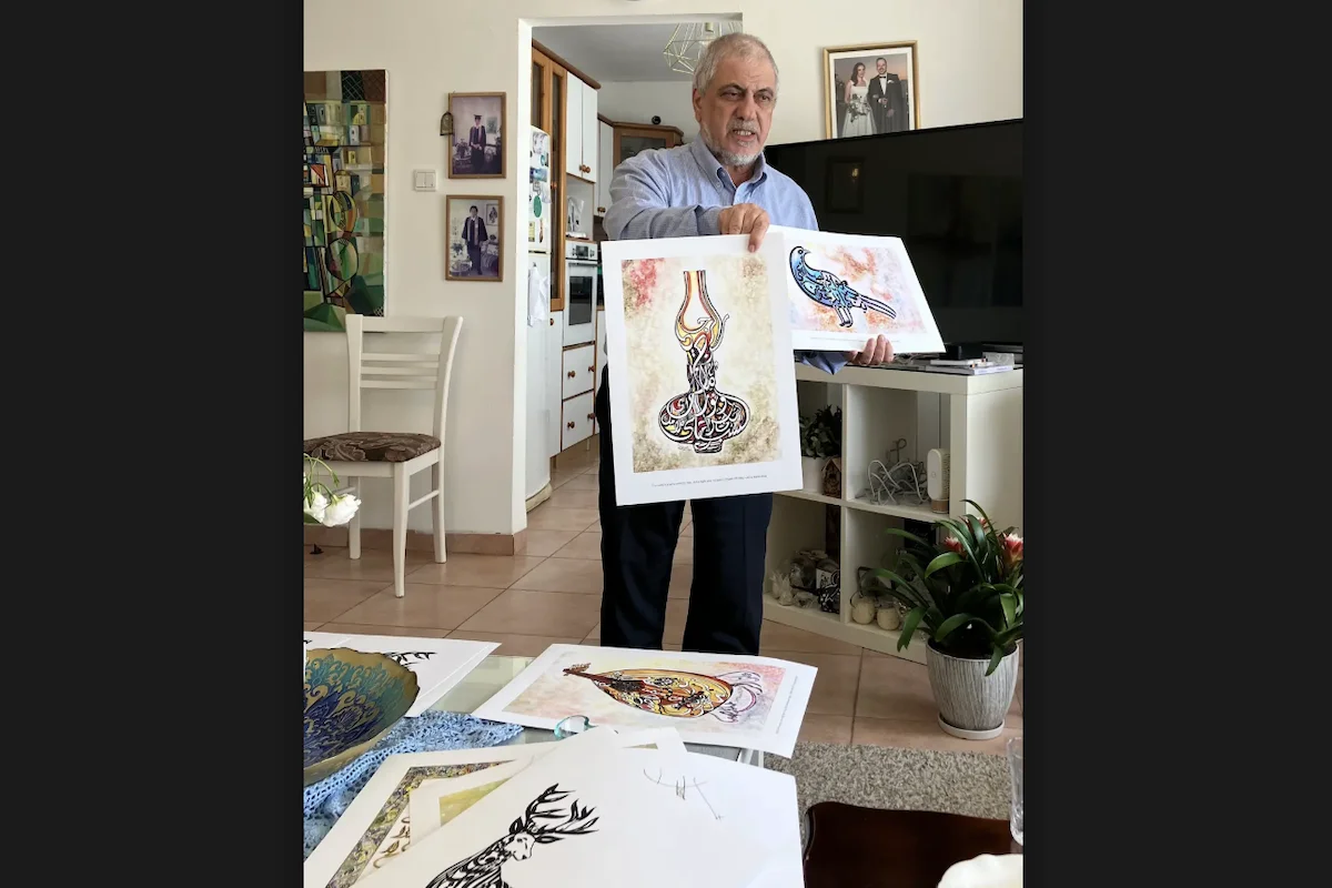 Kamil Dow showing some of the artwork