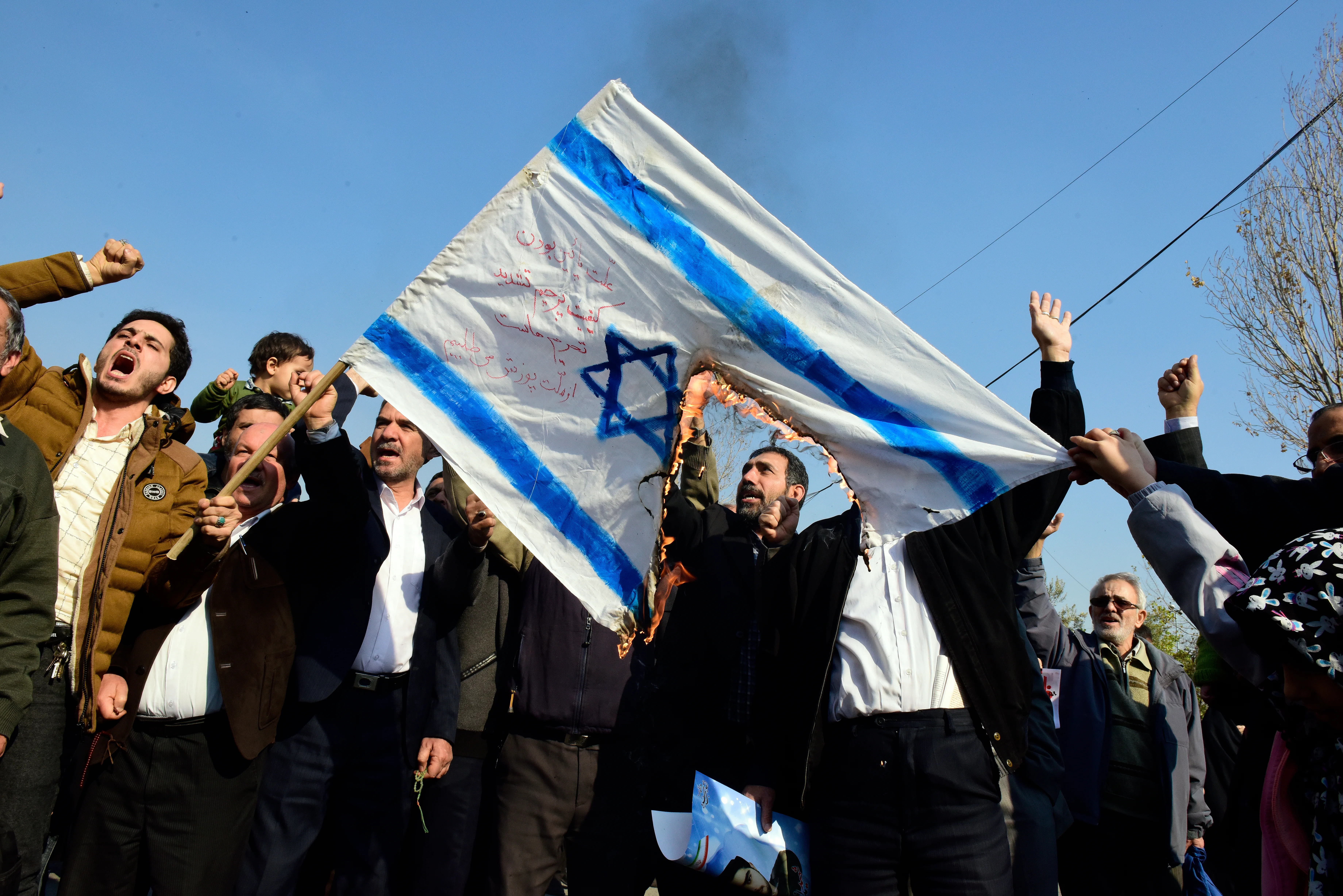 Iranian worshippers burn an Israeli flag after Friday prayer during a rally against anti-government protests, Tehran, Iran, January 5, 2018. (Photo: Shutterstock)