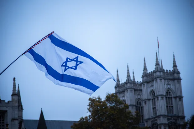 The flag of Israel flies during the March Against Antisemitism, London, England, November 26, 2023. (Photo: Shutterstock)