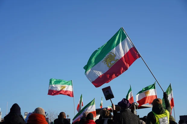 Activists waving Iranian Lion-Sun flags at a protest in Berlin, Germany, January 18, 2026. (Photo: Shutterstock)