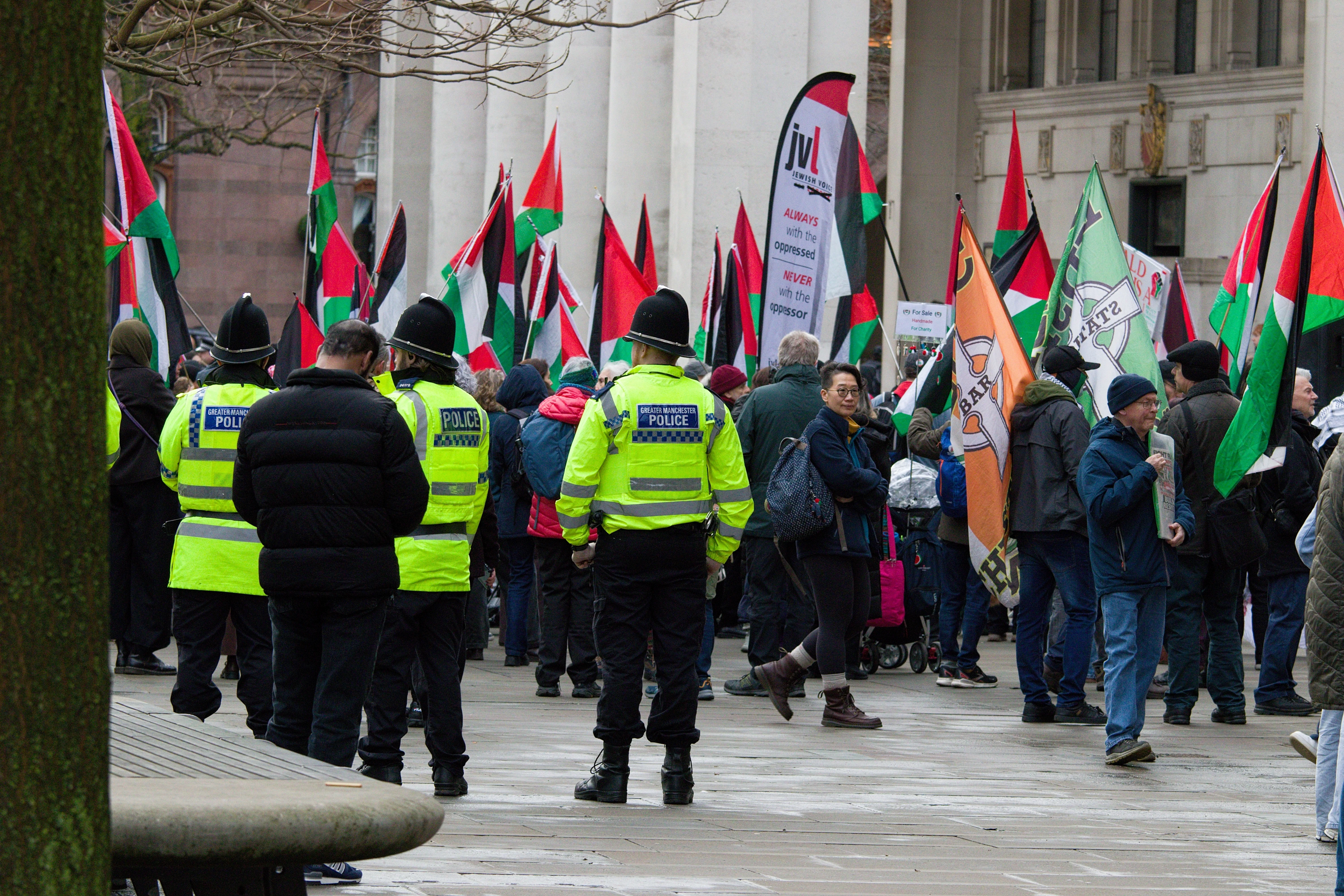 Police keep watch over a protest in Manchester St Peters Square, Manchester, UK