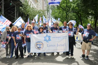 Members of the East Meadow Beth-El Jewish Center hold a banner reading 'Loves Israel' while waving Israeli and American flags up Fifth Avenue at the Israel Day on Fifth parade, New York, May 31, 2026. (Photo: Shutterstock)