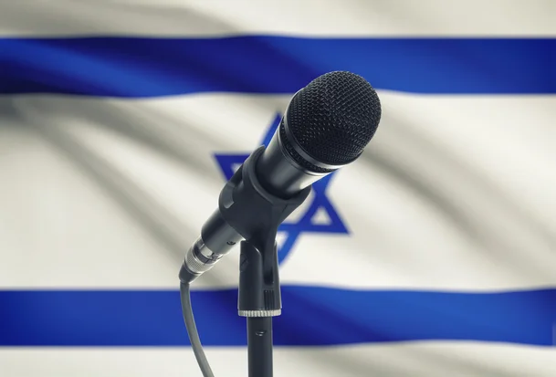 Microphone with Israel national flag on background, Israel, 9 July 2015 Photo: Shutterstock