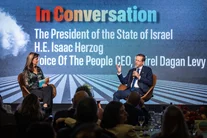 Israeli President Isaac Herzog speaks with Shirel Dagan Levy