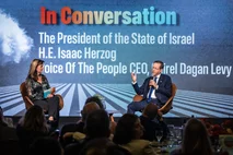 Israeli President Isaac Herzog speaks with Shirel Dagan Levy